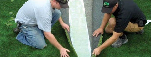 professionals installing and seaming artificial grass together