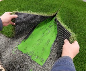 seaming together two pieces of artificial grass