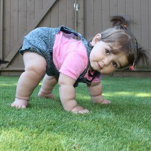 Girl playing on the artificial grass