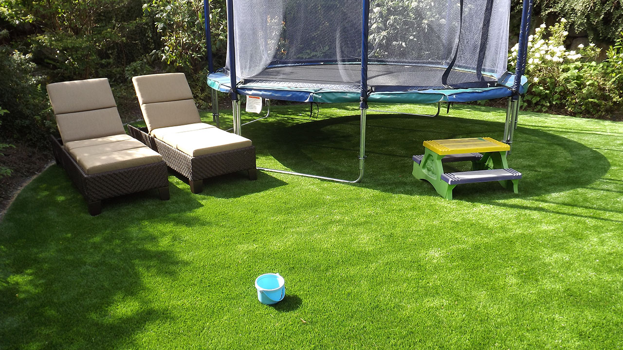 artificial grass with trampoline in backyard