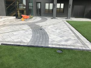 Artificial Grass Backyard used for landscaping with paver stones