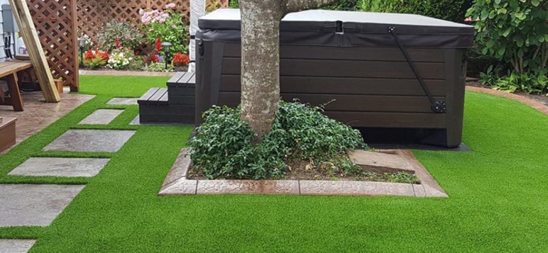 Artificial Grass backyard landscape with hot tub